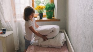 web3-girl-cleaning-up-bed-room-window-shutterstock_441527410-file404-ai