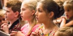 CHILDREN KNEELING AT MASS