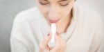 Woman using lipstick