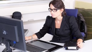 WOMAN WORKING IN OFFICE