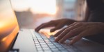 WOMAN TYPING LAPTOP