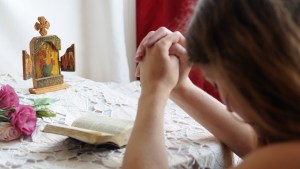 Young girl praying at home