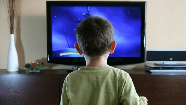 KID IN FRONT OF A TV