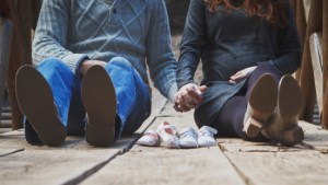 COUPLE SITTING,HOLDING HANDS