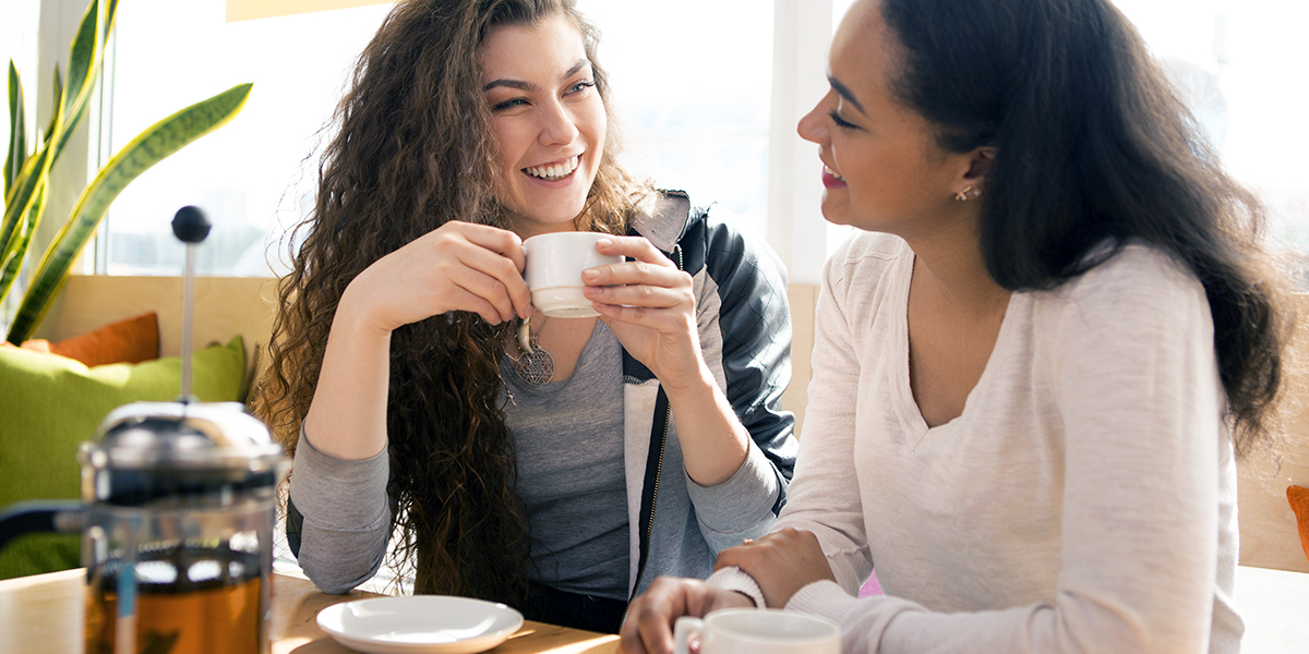 WOMEN CHATTING OVER COFFEE