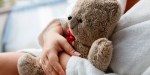 WOMAN HOLDING BEAR