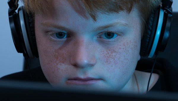 BOY WORKING ON COMPUTER