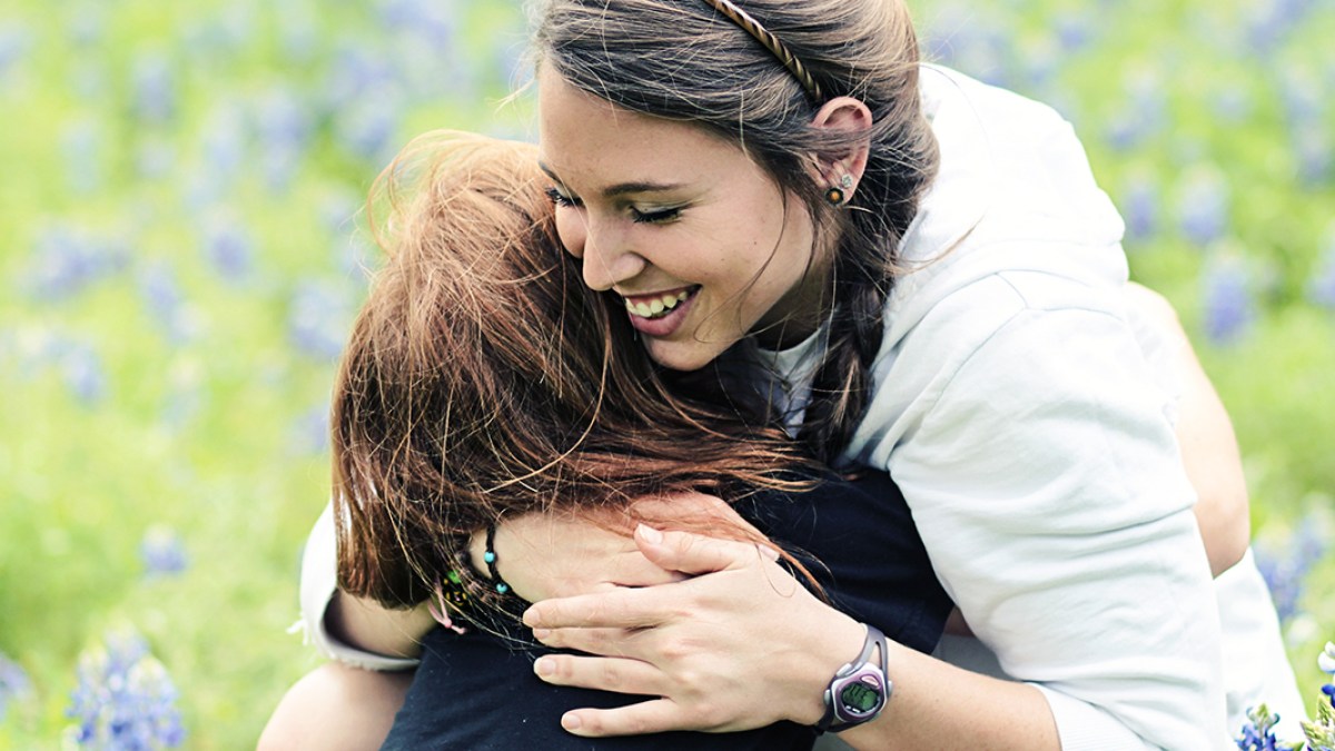 SISTERS HUGGING