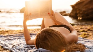 WOMAN READING BEACH