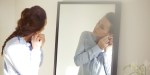 WOMAN,GETTING,DRESSED