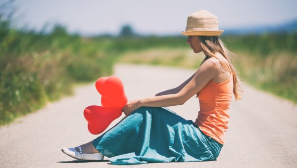 WOMAN SITTING ON THE ROAD
