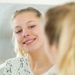 WOMAN LOOKING AT REFLECTION