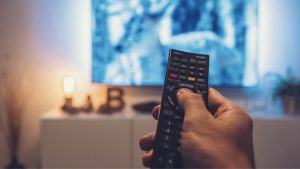 WEB2 – man Watching movie and using remote control – shutterstock_731073736.jpg
