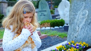 CHILD AT GRAVE