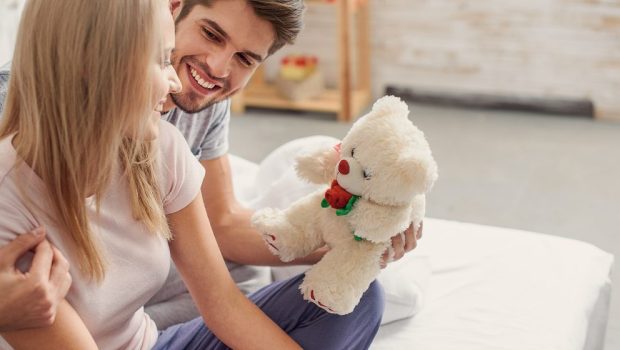 WOMAN RECEIVING TEDDY BEAR