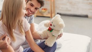 WOMAN RECEIVING TEDDY BEAR