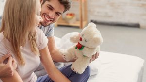 WOMAN RECEIVING TEDDY BEAR