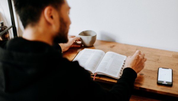 mężczyzna czyta Pismo święte o poranku przy kawie