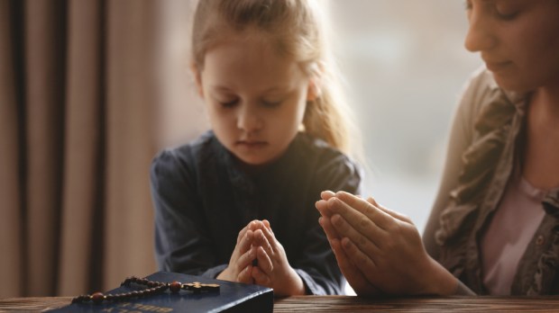 Girl praying rosary
