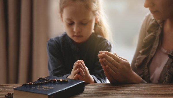 Girl praying rosary