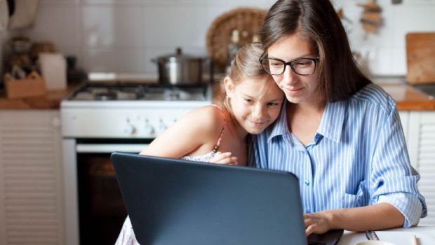 Mother and daughter using laptop