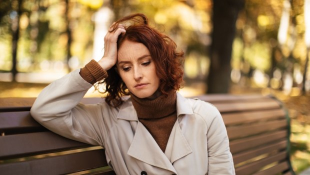 Tired woman sitting on a bench