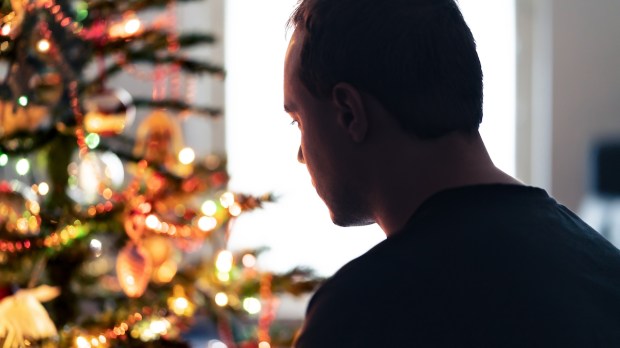 Lonely christmas with sad family conflict or grief on holiday Man with stress
