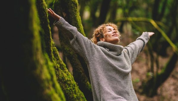 happy woman enjoying the green beautiful nature