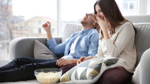 Couple watching tv and laughing