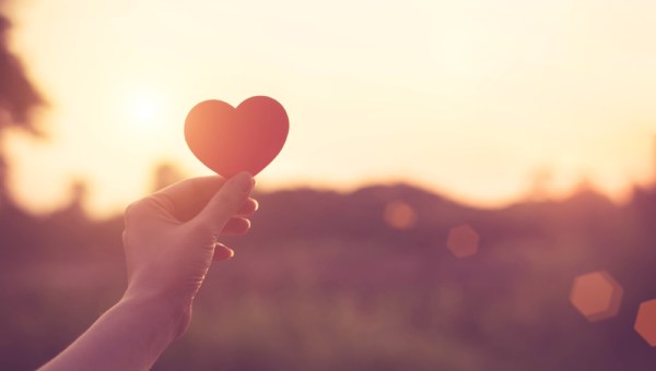 Woman holding paper heart