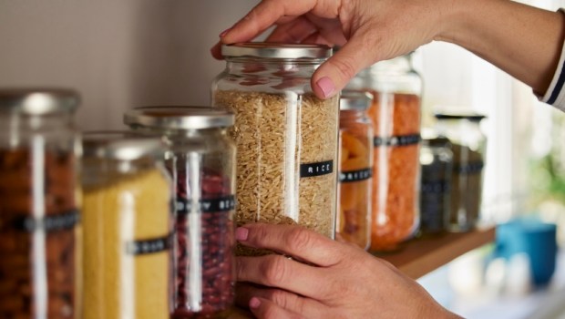 Woman Reusing Glass Jars To Store Dried Food Living Sustainable Lifestyle At Home