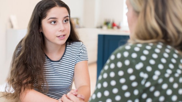 Mother Having Serious Conversation With Teenage Daughter At Home