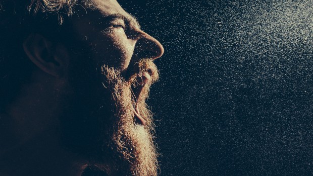 bearded-man-angrily-screams-into-a-spray-of-water-shutterstock