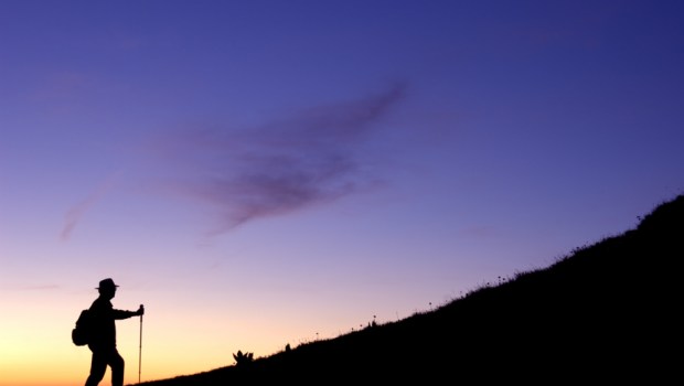 walker climbs a ridge