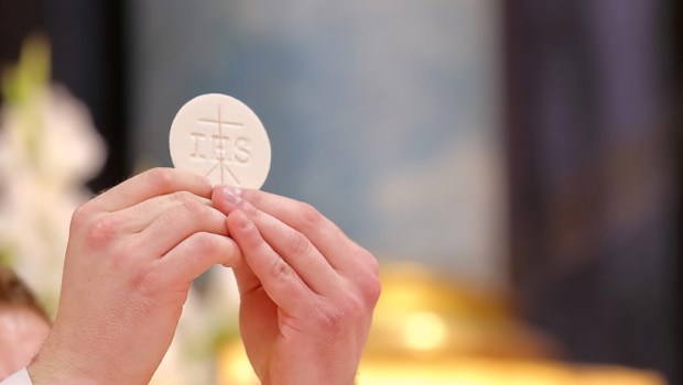 Holy host in the hands of the priest