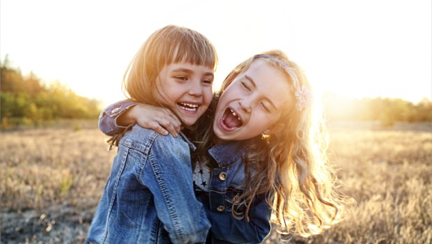 Two young girls have fun outside
