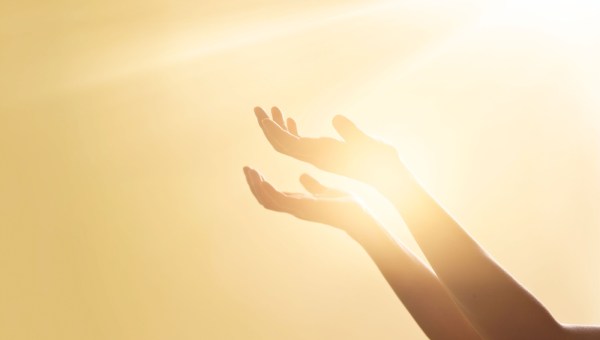 Woman hands praying for blessing from god on sunset background
