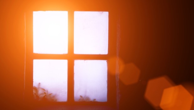 A ray of morning sun in an old window