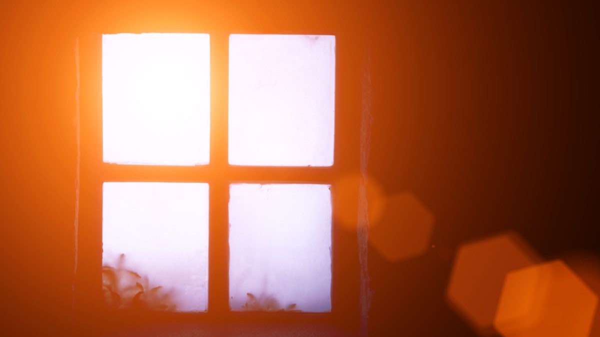 A ray of morning sun in an old window