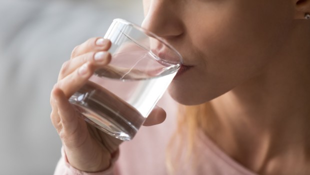 thirsty woman holding glass drinks still water preventing dehydration