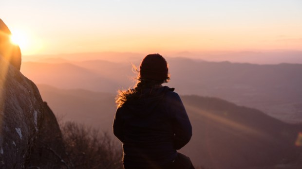 Amazing Landscape Photo With Silhouette of Woman on Hiking Adventure to Mountain Peak