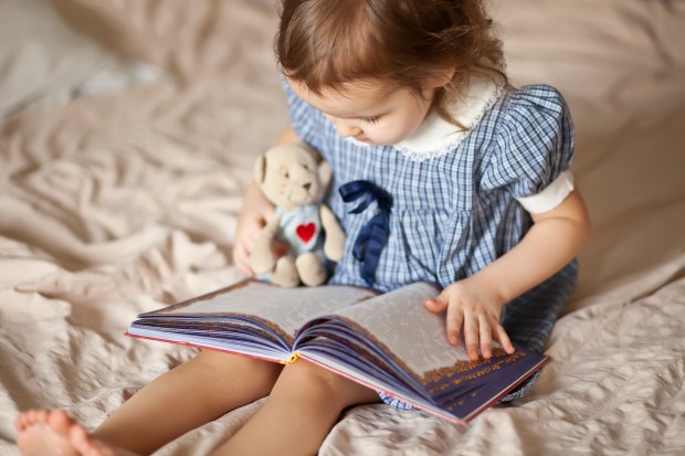 trust child reading teddy bear