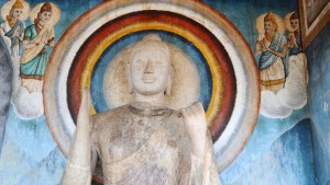 Buddha image statue with beautiful paints on the background on DEC 29, 2013 in Anuradhapura, Sri Lanka