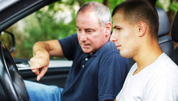 Father teaching his son how to drive