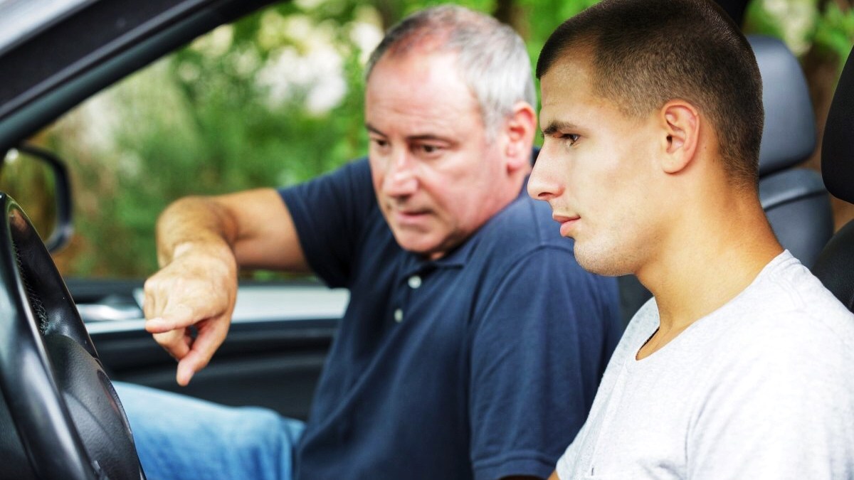 Father teaching his son how to drive
