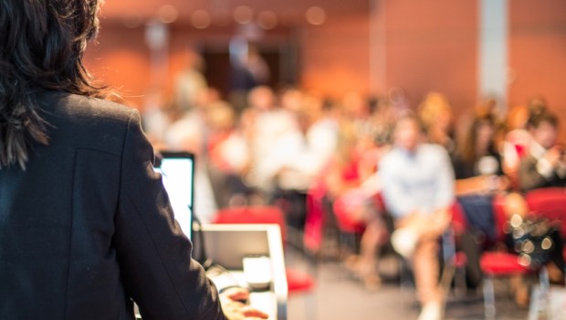 Female speaker giving a talk on corporate business conference