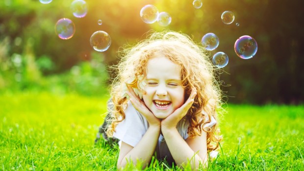 Girl lying in green grass. Healthy Smiling. Medical concept