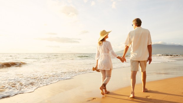 Happy Romantic Middle Aged Couple Enjoying Beautiful Sunset Walk on the Beach