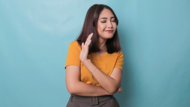 Stop. Concerned Asian woman showing refusal sign, saying no