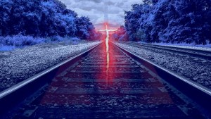 Glowing cross over railroad tracks